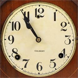 Gilbert Clock Company eight-day mahogany cased mantle clock, with a cream card dial, break arch top, upon a raised plinth, H28cm