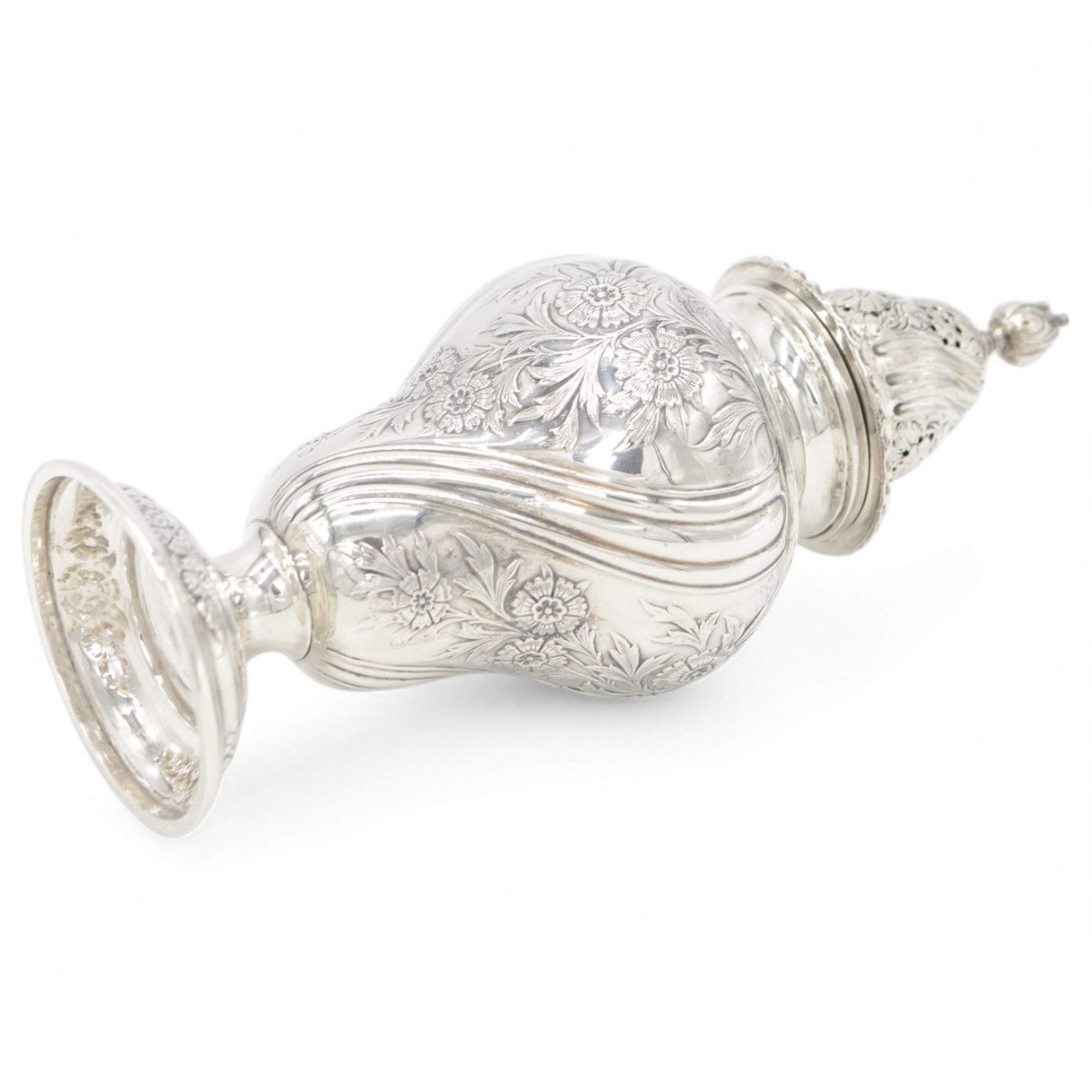 Edwardian silver sugar caster, of typical form embossed with floral decoration, the removable pierced cover with oblique gadrooned rim and bud finial, upon a circular stepped foot, hallmarked Hawksworth, Eyre & Co Ltd, London 1901, H20cm