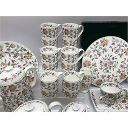 Minton Haddon Hall pattern tea and dinner wares, including basket dish, two covered tureens, six dinner plates, eight dessert plates, twelve tea plates, six soup bowls, six cereal bowls, teapot, coffee pot, milk jug, covered sucrier twelve tea cups and saucers, six mugs, footed bon bon dish, pair of candlestick holders, cake knife and slice etc (81)