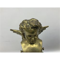 Pair of brass fire kerb supports, each modelled as the bust of a putto above a floral swag and musical trophy, H43cm