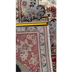 Central Persian Kashan rug, ivory and teal ground, overall geometric design, angular interlaced decorated field with stylised plant motifs, crimson ground, central medallion, the crimson main border band decorated with geometric motifs