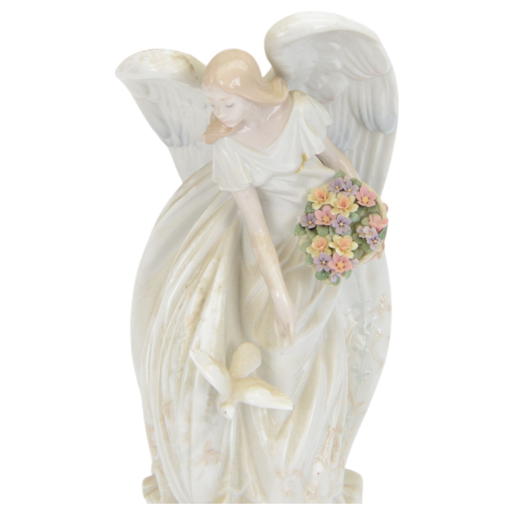 Lladro figure Flowers of Peace, modelled as an angel holding flowers, no 1867, H33cm