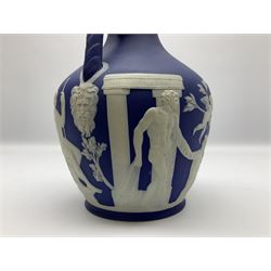 19th century Wedgwood dark blue dipped Jasperware Portland vase, of ovoid form with twin handles to shoulders and waisted neck, and flared rim, the body decorated with a continuous scene of classical figures in relief, the base decorated with portrait in relief, H26cm