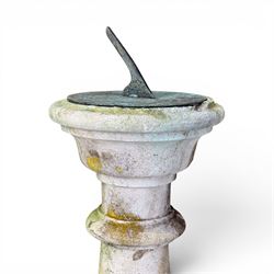 Large weathered cast stone sundial, raised on circular column of bulbous form, square plinth base