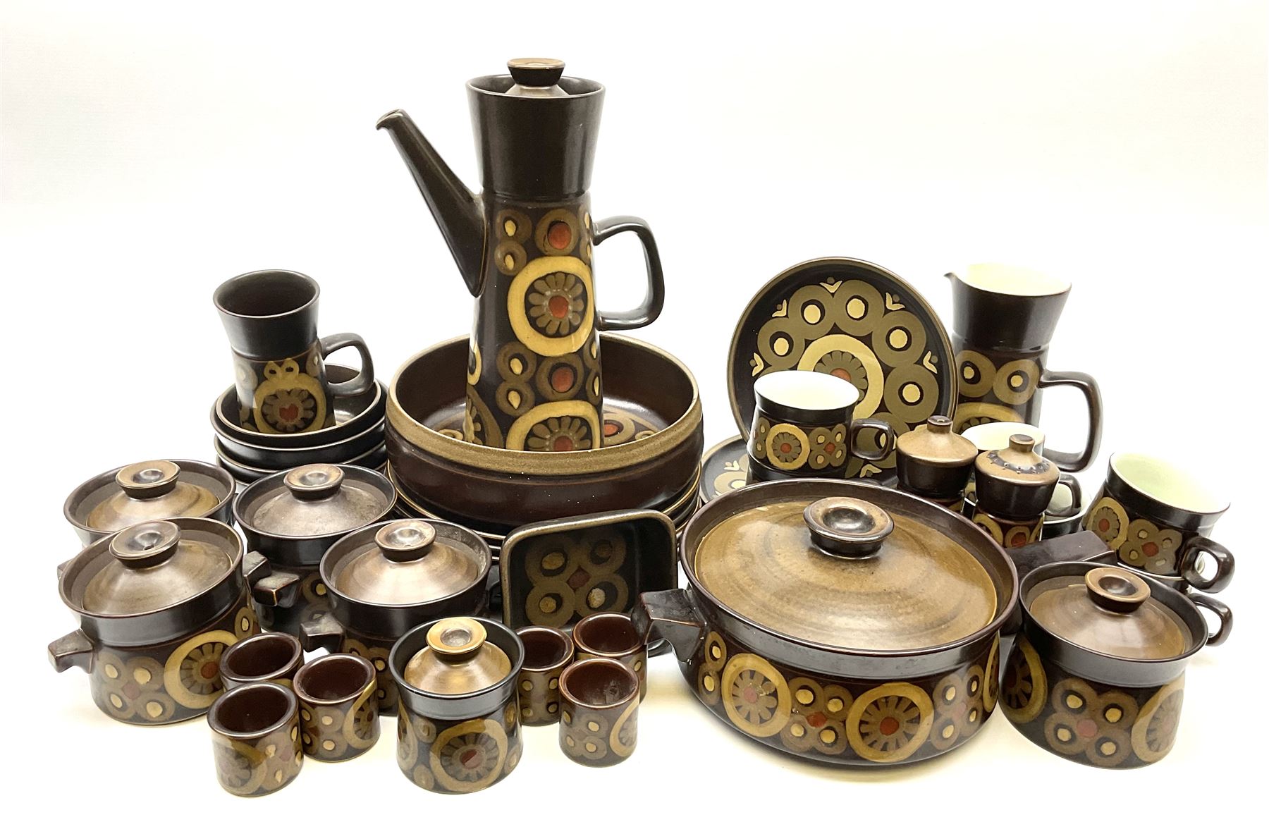 Denby Arabesque pattern tea and dinner wares, comprising large serving bowl,  five dinner plates, three side plates, four twin handled bowls and covers, one bowl and cover, four bowls, salt and pepper shaker, pan with lid, six egg cups, small serving dish, coffee pot, water jug, milk jug, jug with handle,  two sucriers and covers, four tea cups and one coffee