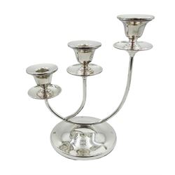 Modern silver graduated candlestick, the circular domed and filled foot supporting curved stems leading to three plain sockets over drip pans, hallmarked Barker Ellis Silver Co, Birmingham 2000, H22cm