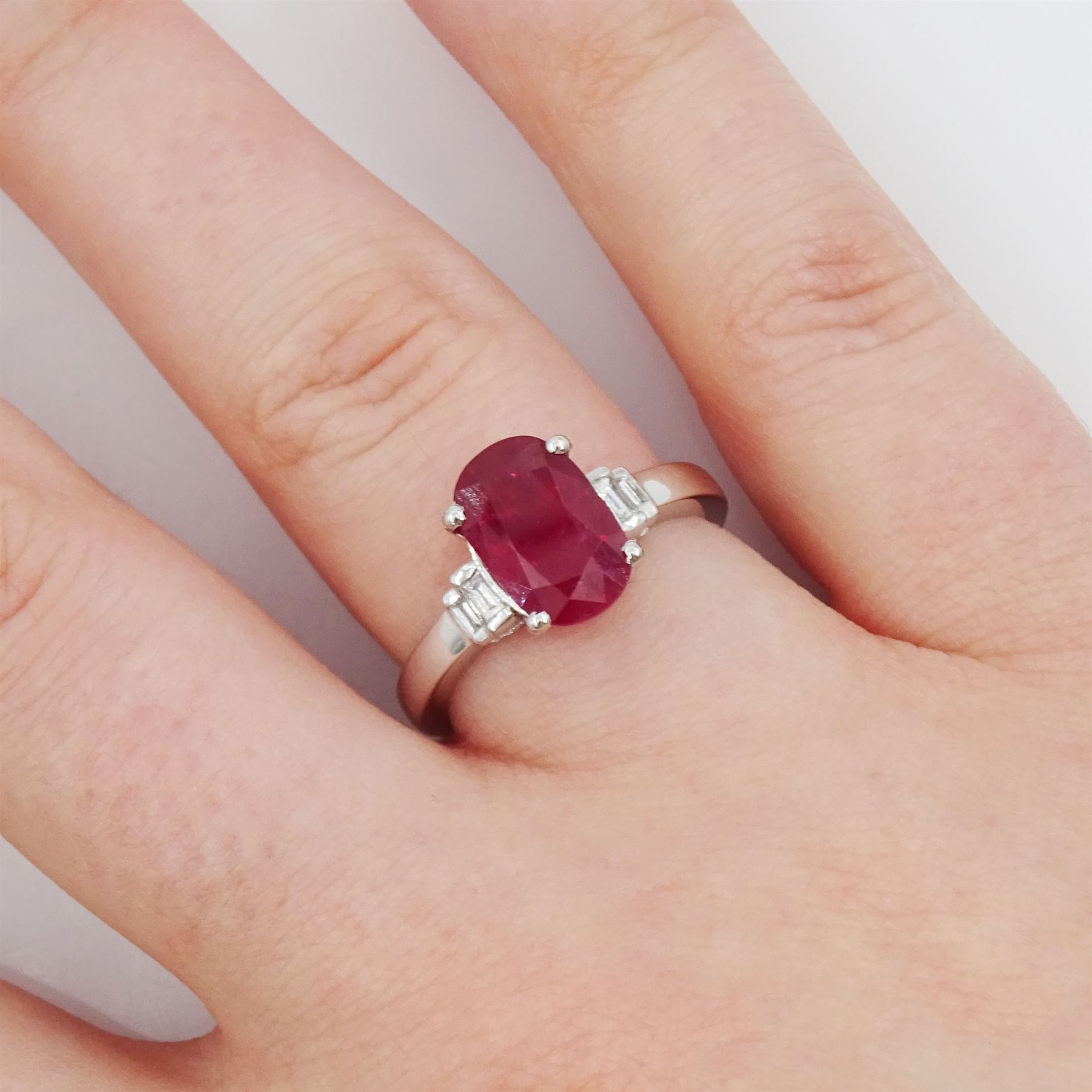 18ct white gold oval cut ruby and four stone baguette cut diamond ring, hallmarked, ruby approx 3.00 carat