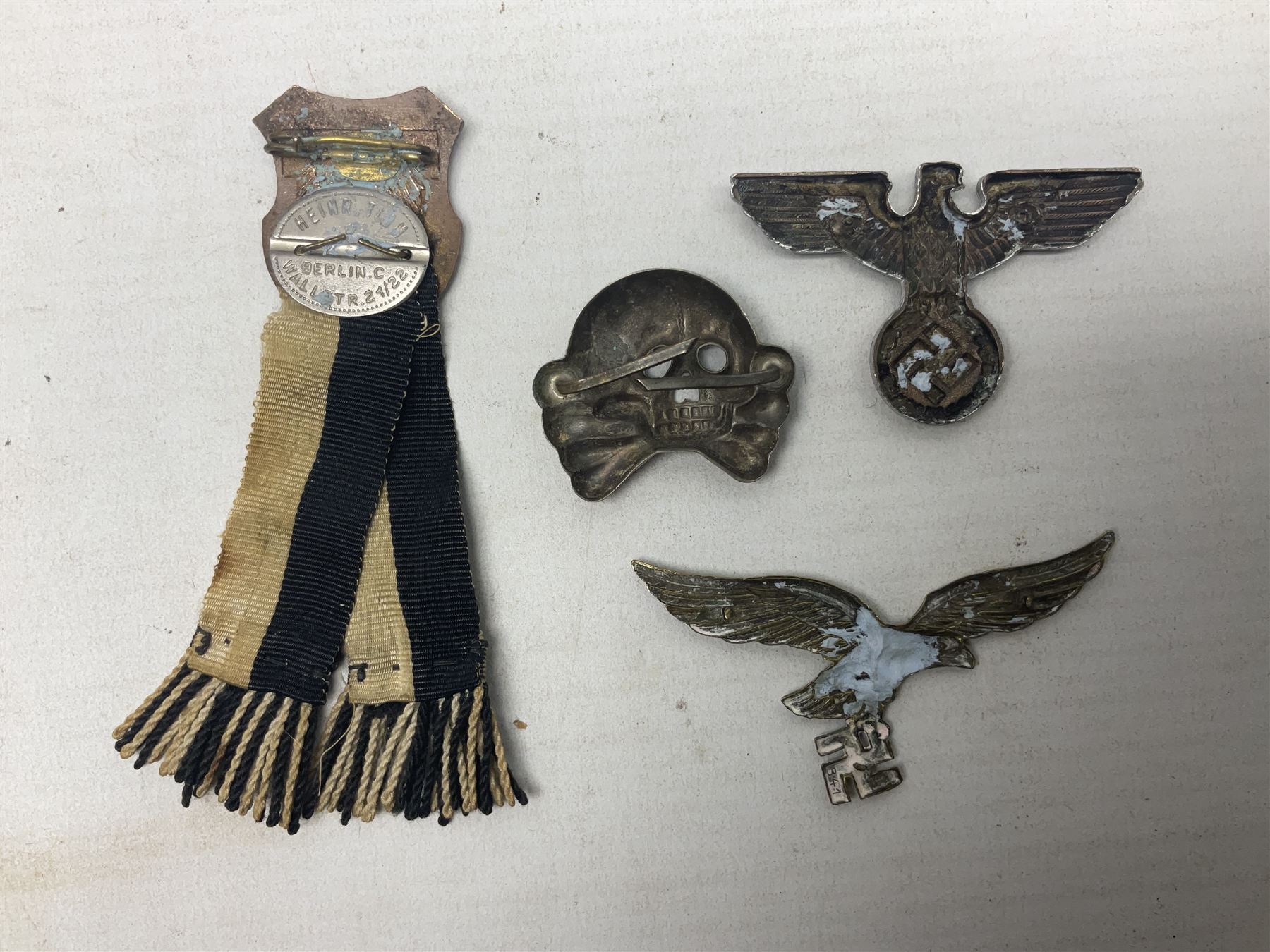 Imperial German Prussian Army Service Veterens Association badge; 'SS' type first pattern cap skull; Luftwaffe metal eagle uniform insignia; and another metal eagle cap insignia (possibly police?) (4)