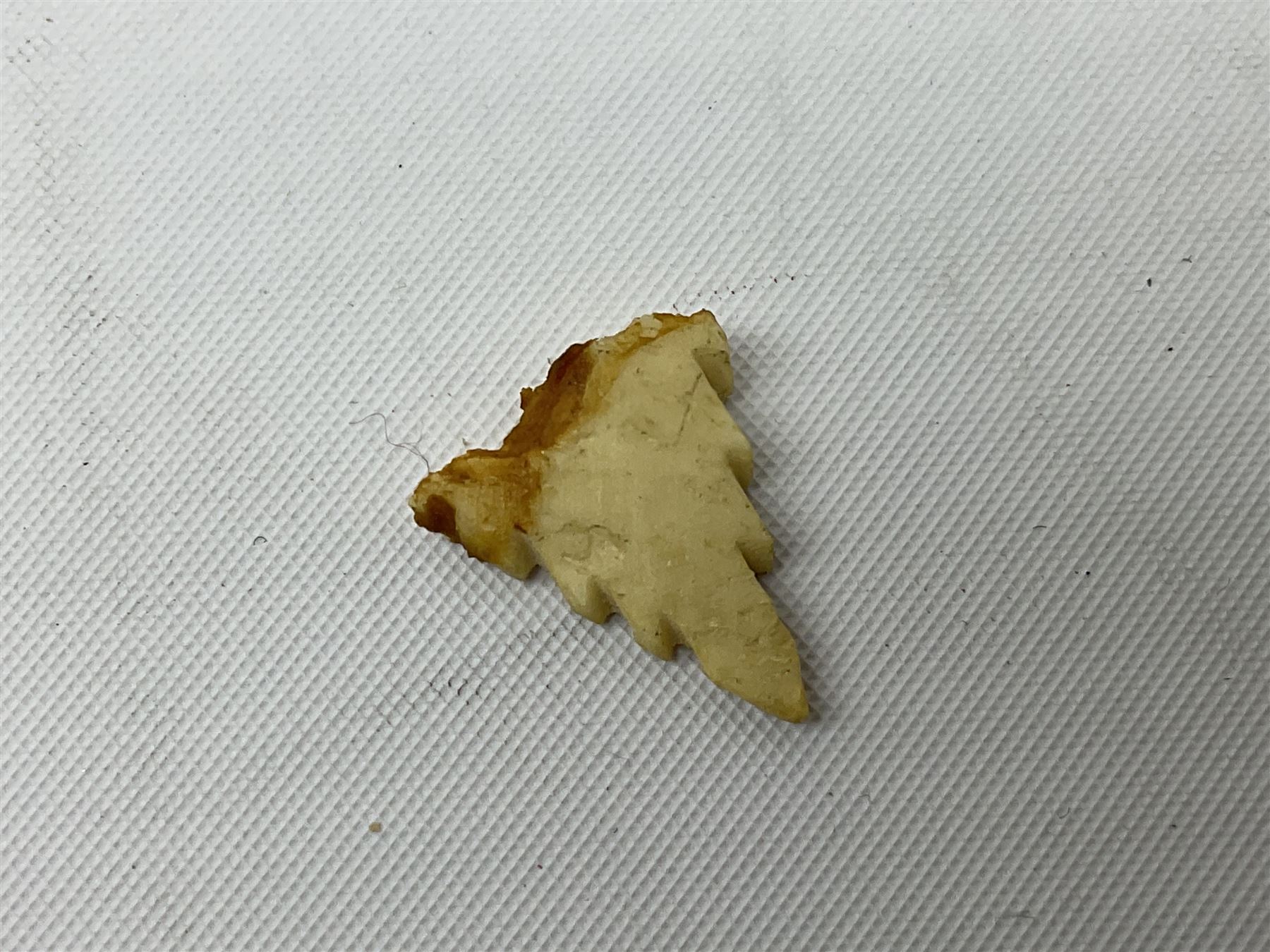 Hardwood bust of an Indoniesian Goddess, carved wearing a pierced headdress, from Klungkung, Bali, H20cm, together with a pair of bone carvings of deity figures, and a carved wood Netsuke in the form of a Chinese dragon