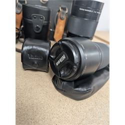 Kodak Dakon II folding camera and a collection of camera lenses and accessories, including Reflex-Nikkor  1:8 f=500mm, NikoN AF Nikkor 70-300mm 1:4-5.6G, Micro TM monocular lens and Teleshot adapter, two cases, Weston exposure meter, two cases etc