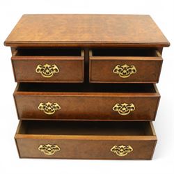 Late 20th century figured walnut miniature chest, the rectangular top with feather banded border over two short and two long drawers, fitted with brass batwing handles, upon moulded plinth base and four bracket feet, H60cm, w67cm, D36cm