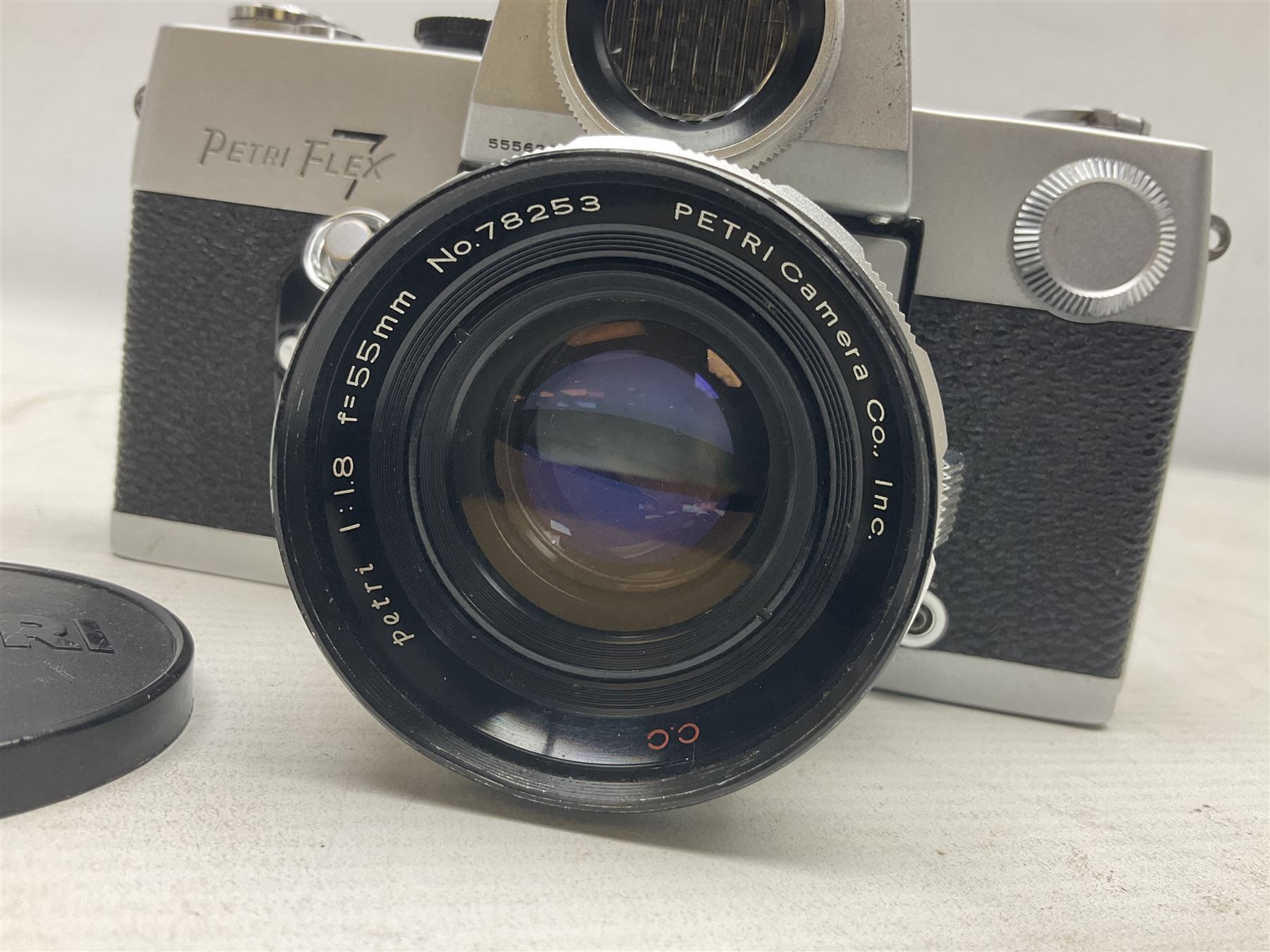 Petri Flex 7 camera body, serial no. 555698, with Perti C.C 1:1.8 f=55mm' lens, serial no. 78253, together with Petri Flex V2 camera body, serial no. 364427, with 'Petti C.C. 1:2 f=55mm' lens, serial no. 137076, in ever ready case