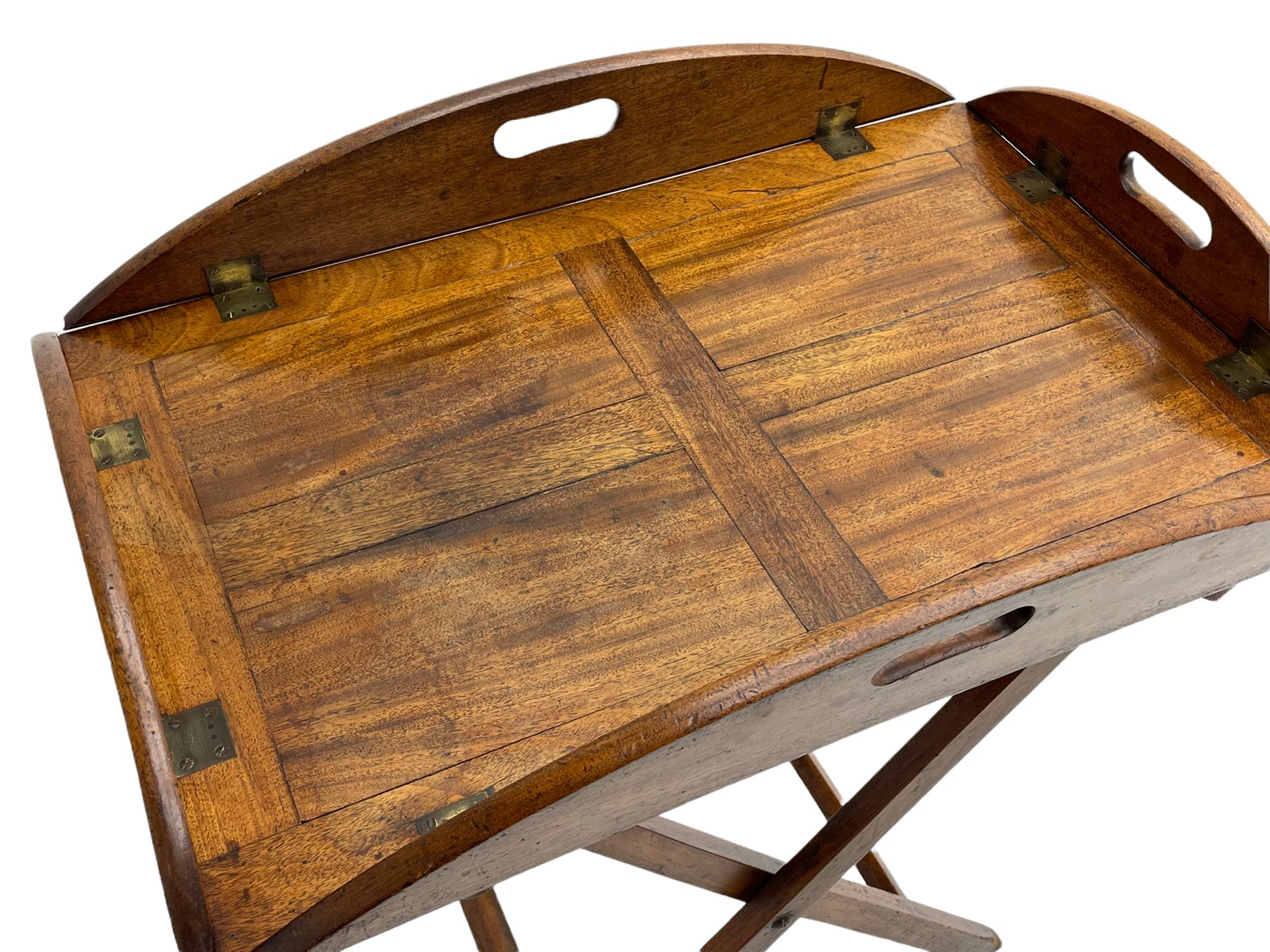 George III mahogany butler's tray on stand, the panelled tray with hinged sides pierced with handles, on folding stand