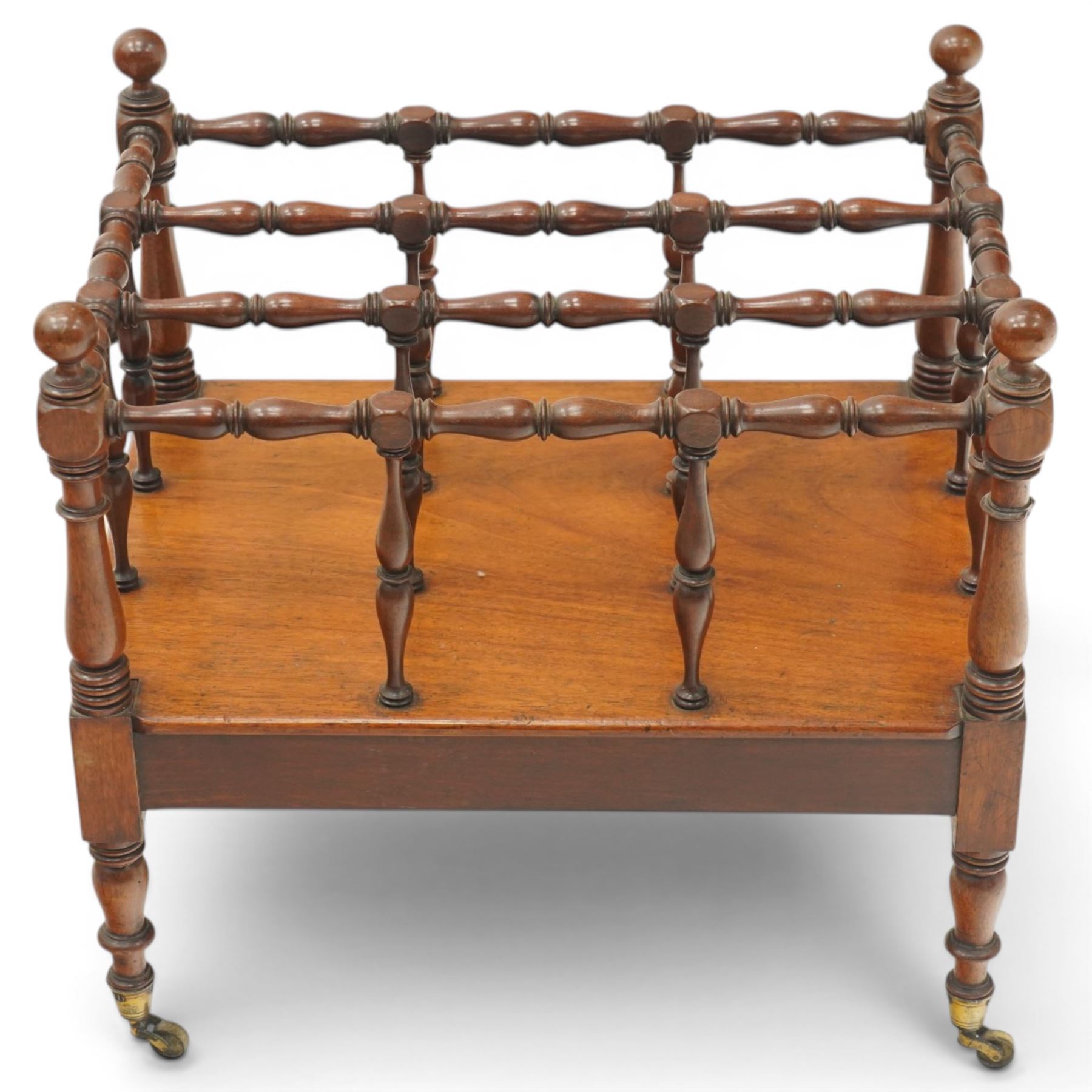 Victorian mahogany canterbury, four division top with bobbin turned rails and spindle uprights, rectangular base with moulded edge, on turned corner supports with brass castors
