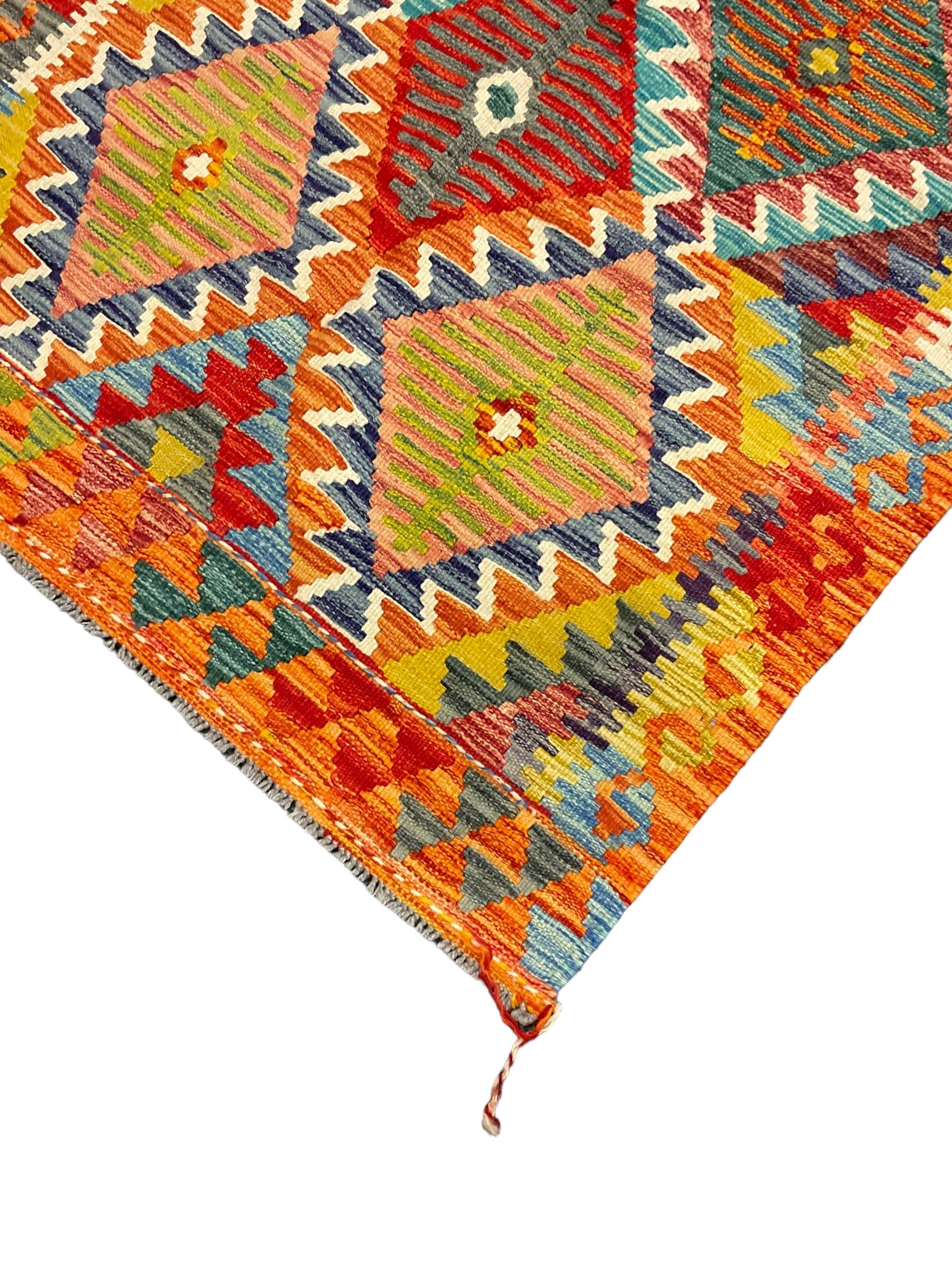 Chobi Kilim rug, multi-coloured ground in oranges, blues and greens, overall geometric design 