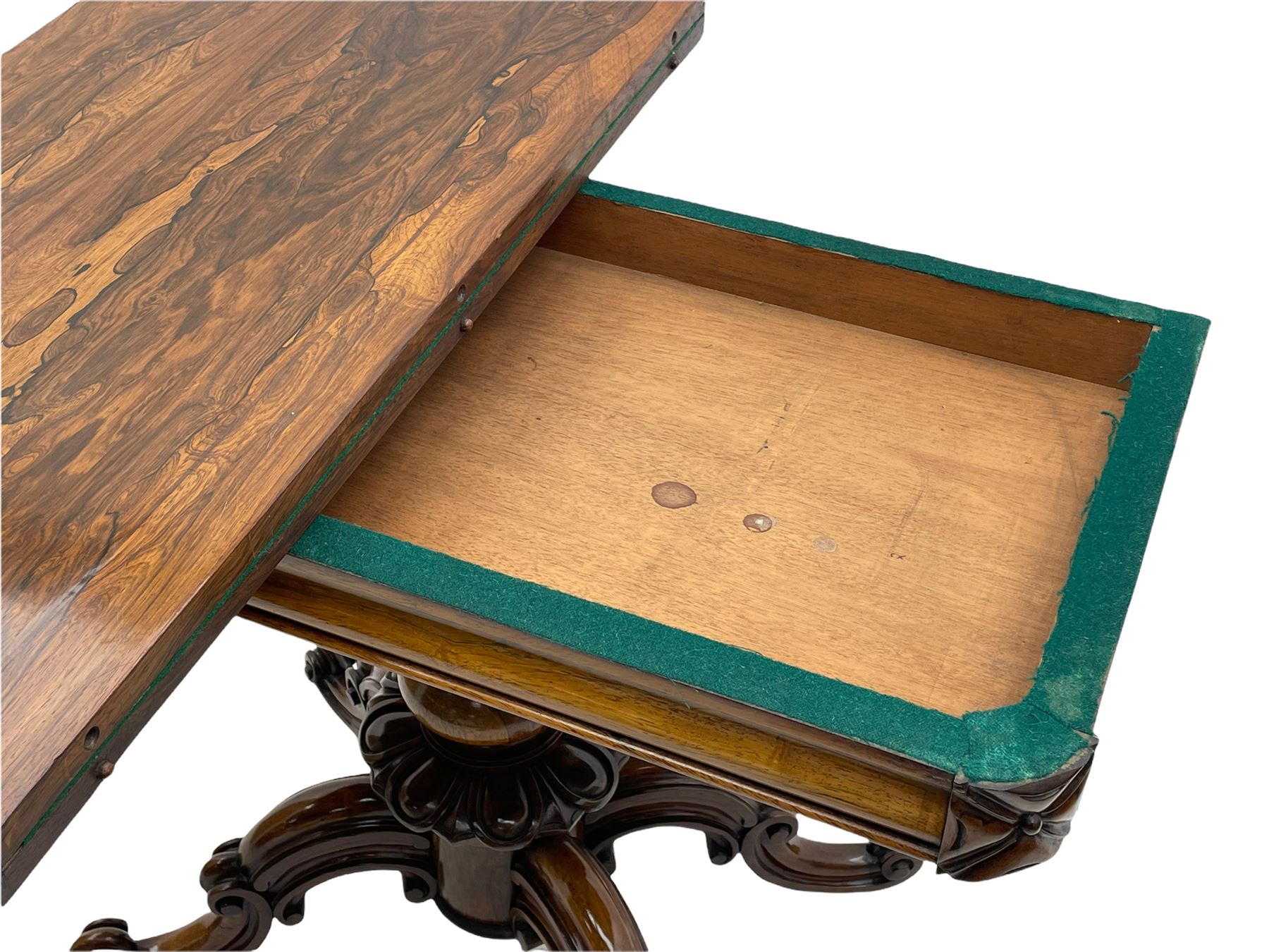 Victorian figured rosewood card table, fold-over swivel top with circular baize lining, moulded frieze with stylised flower head carving to corners, turned column with egg and dart decoration, on quadruple splayed c-scroll carved supports, with brass castors