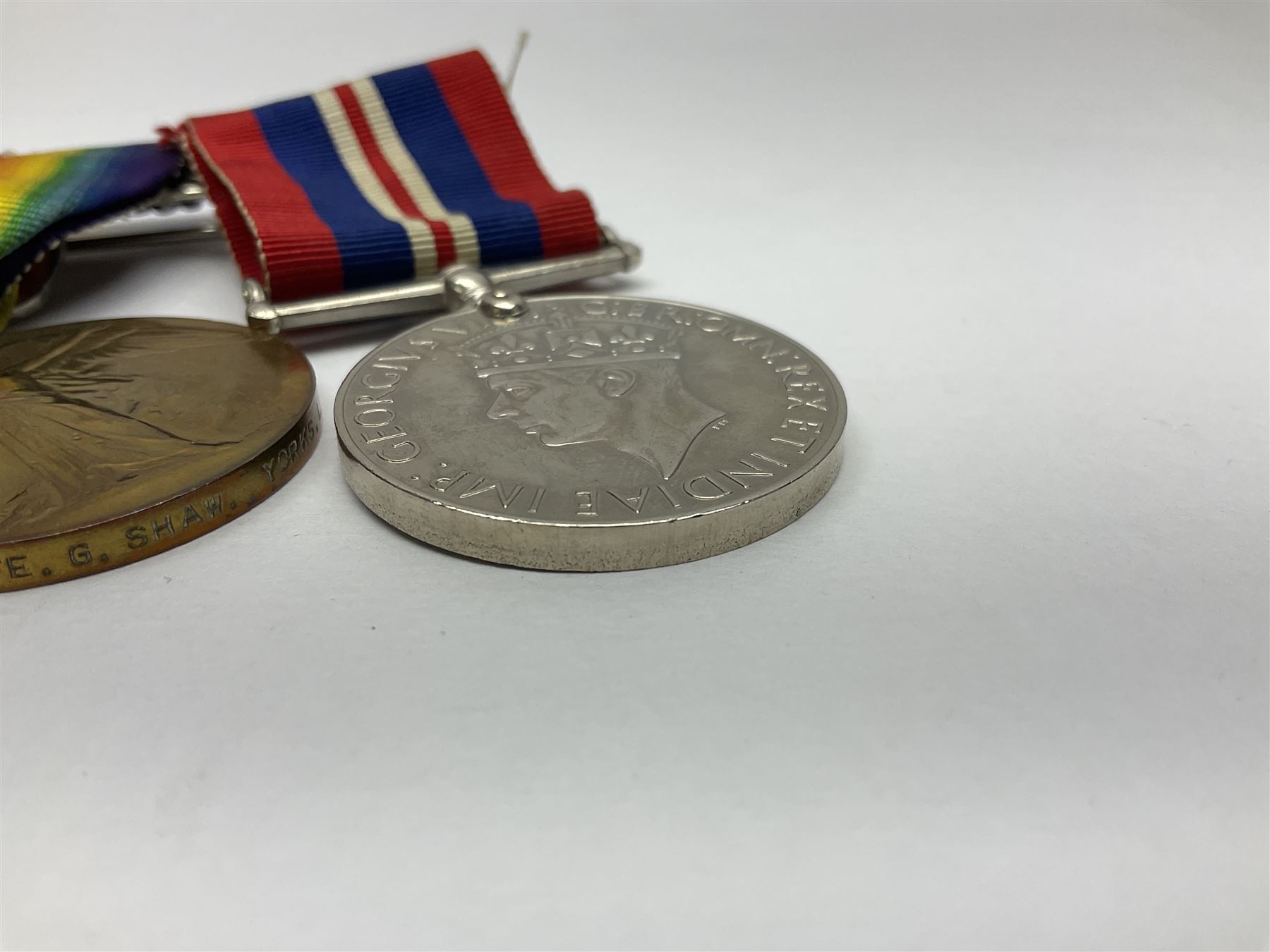 WW1 group of three medals comprising British War Medal, Victory Medal and 1914 Star awarded to 8328 Pte. G. Shaw Yorks: L.I.; on hanging bar with WW2 1939-1945 War Medal and WW1 ribbon bar with rosette to 1914 Star ; all with ribbons; and WW2 1939-1945 War Medal with ribbon