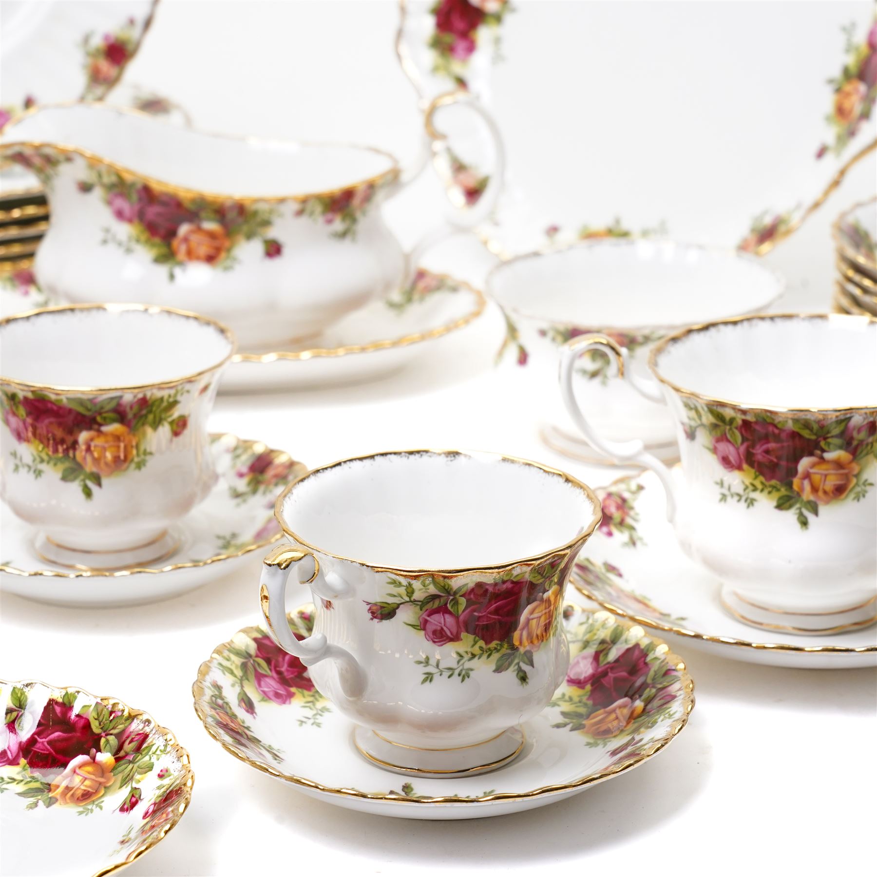 Royal Albert Old Country Roses tea and dinner ware comprising six dinner plates, five dessert bowls, sauce boat and stand, four breakfast cups and saucers, three tea cups and four saucers, six tea plates, milk jug, sugar bowl and bread and butter plate