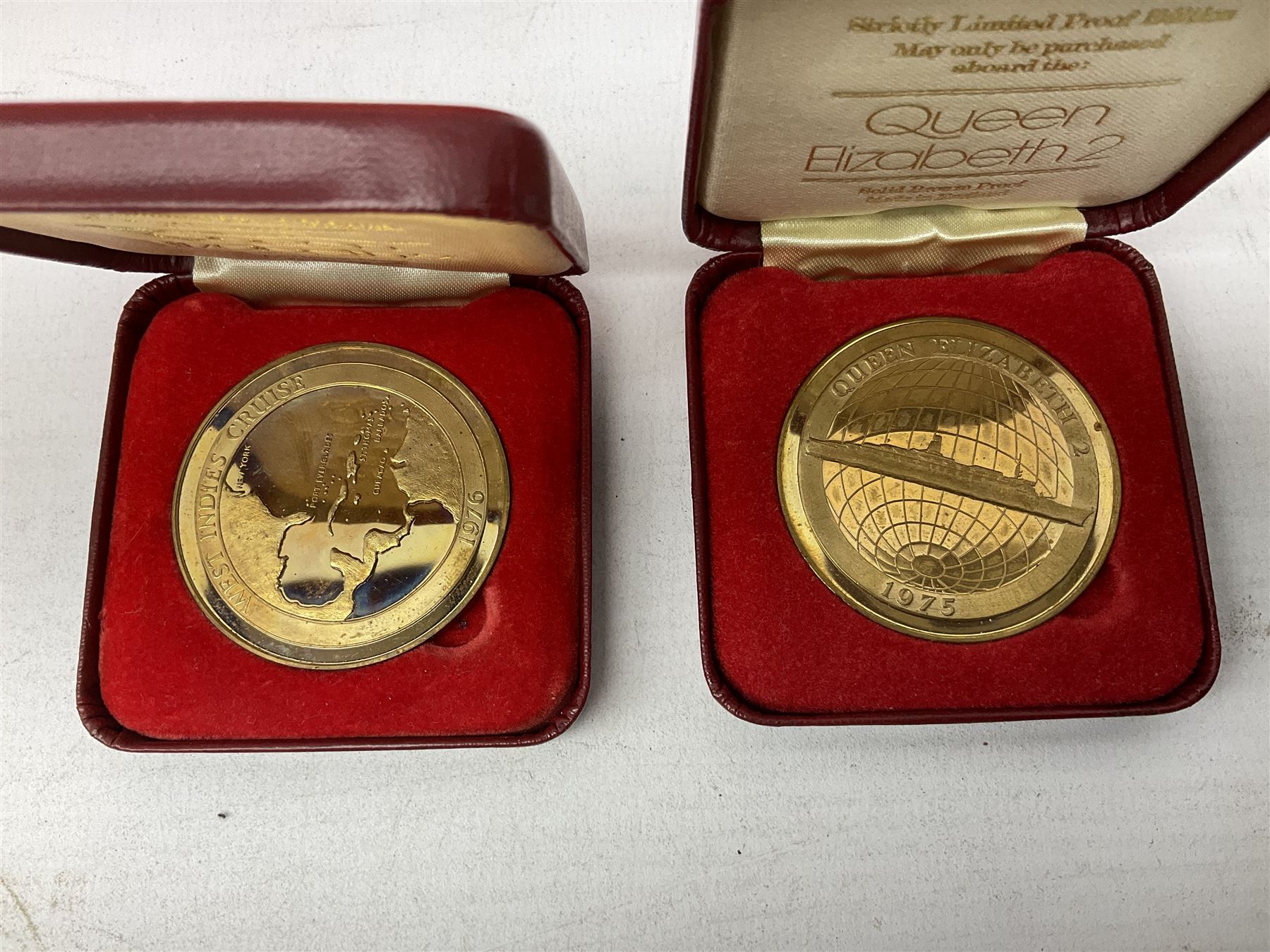 Queen Elizabeth II cradle of civilization cruise 1976 bronze medallion with related book and two other Queen Elizabeth II commemorative medallions for cruises in 1975 and 1976, all cased