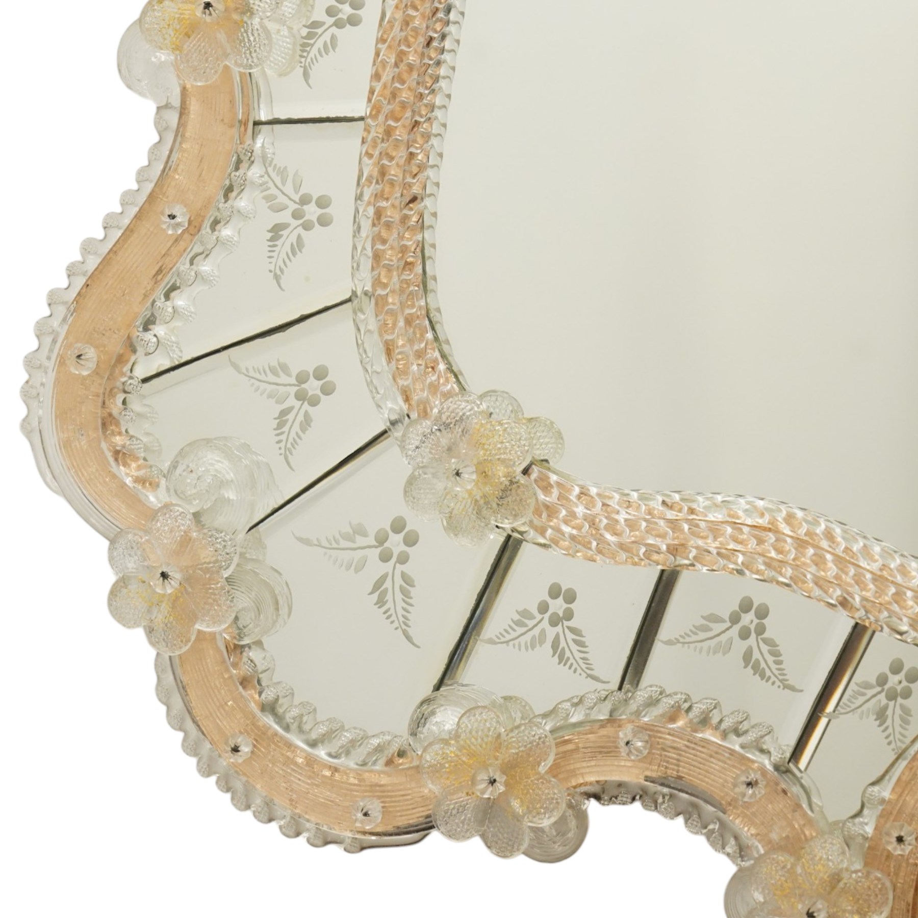 20th century Venetian glass wall mirror, the shaped plate within a mirrored frame applied with clear glass flowerheads and moulded glass edging, with etched floral decoration to the bevelled 'frameless' plates, the inner slip with ropetwist moulded glass