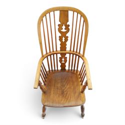 19th century elm Windsor armchair, with central pierced splat, flanked by spindles, dished seat, raised on turned supports united by H-stretcher