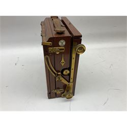 Ensign 'The Sanderson' folding plate camera in mahogany and lacquered brass, field model with canvas wrapped box, two mahogany photographic plates, 'Busch rapid Symmetrical F:8' lens,  and a wooden tripod 