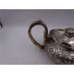 George III Irish silver teapot, of squat circular form, the body with repousse and chased floral and C scroll decoration, with capped C handle and ivory insulators, engraved to base 'Presented to Troop Sergeant Major John Percival, of the 4th Dragoon Guards by Alex D. Tait, Esq, late Captain in that corps as a mark of approbation of his steady and upright conduct when Sergeant Major of his Troop, Dublin, June 2nd 1843', hallmarked William Law, Dublin 1817, H12.5cm, This item has been registered for sale under Section 10 of the APHA Ivory Act