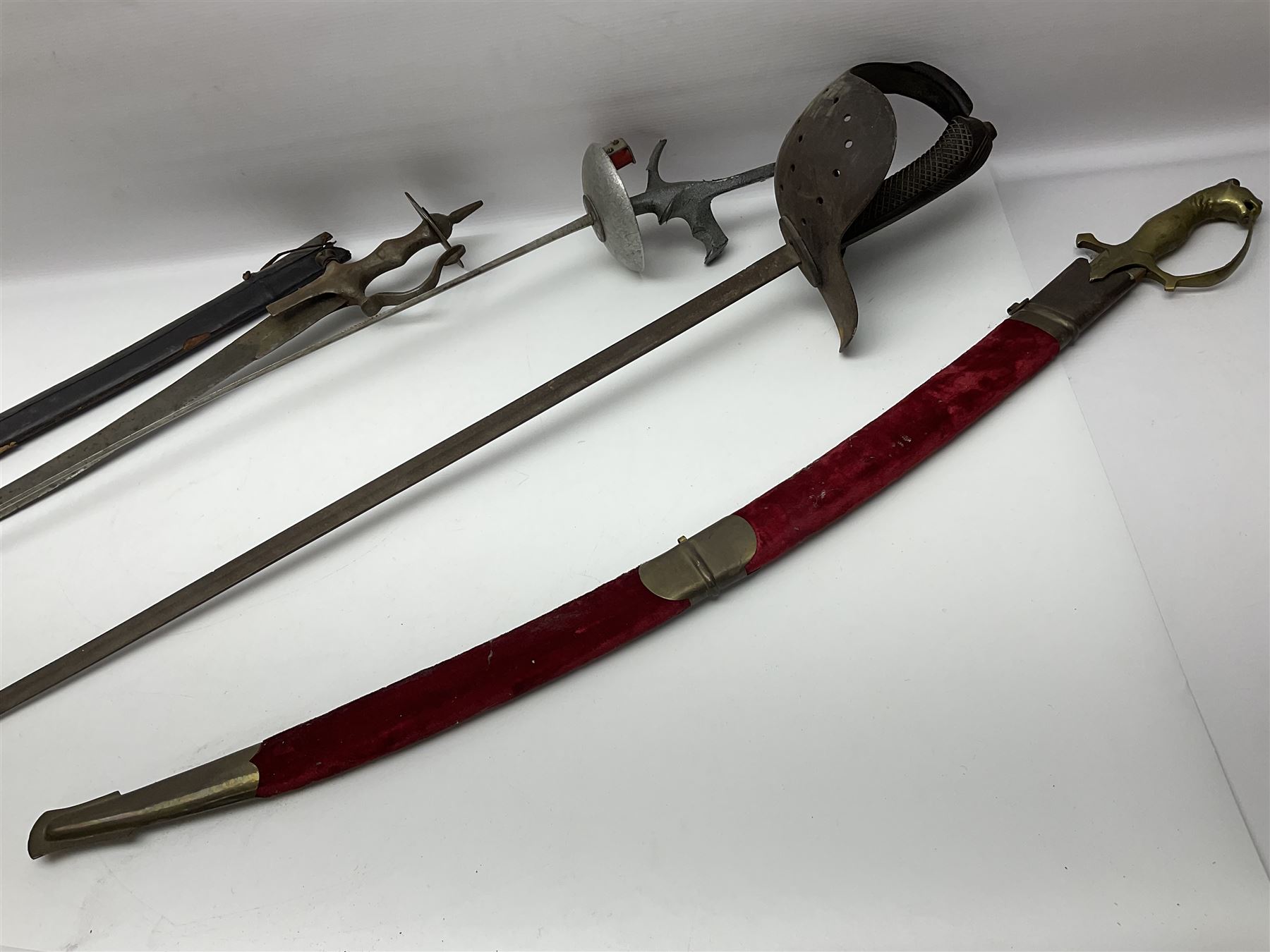 Late Victorian British Military gymnasium practice sword with 85.5cm fullered blunt pointed narrow straight blade, pierced bowl guard and chequered wooden grip L103cm overall; Leon Paul fencing foil with shaped grip and touche wiring; and two reproduction Indian tulwar swords with scabbards (4)