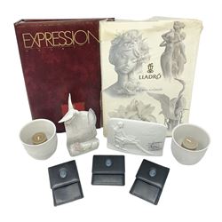 Lladro Collectors Society items, comprising of The Will to Create book, two candle holders; Sailing the Sea no 17665, Dolphins at Play no 17666, Plaque Bringing Us Together, key fob, leather wallet and a members joining pack with plaque, all in original boxes  