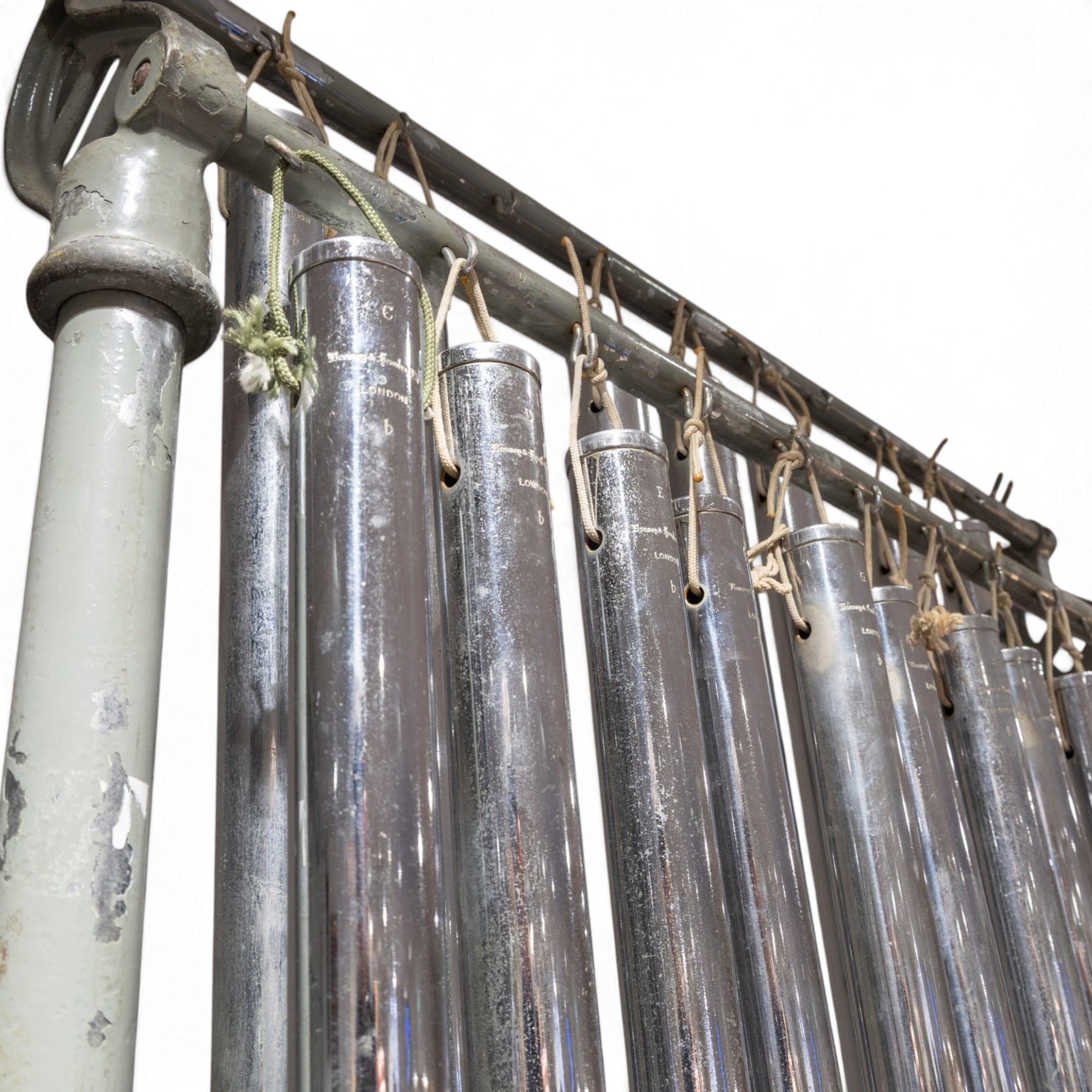Boosey & Hawkes Ltd, London orchestral tubular bells/chimes, the chromed tubes pitch-marked and suspended on painted metal frame, frame H186cm