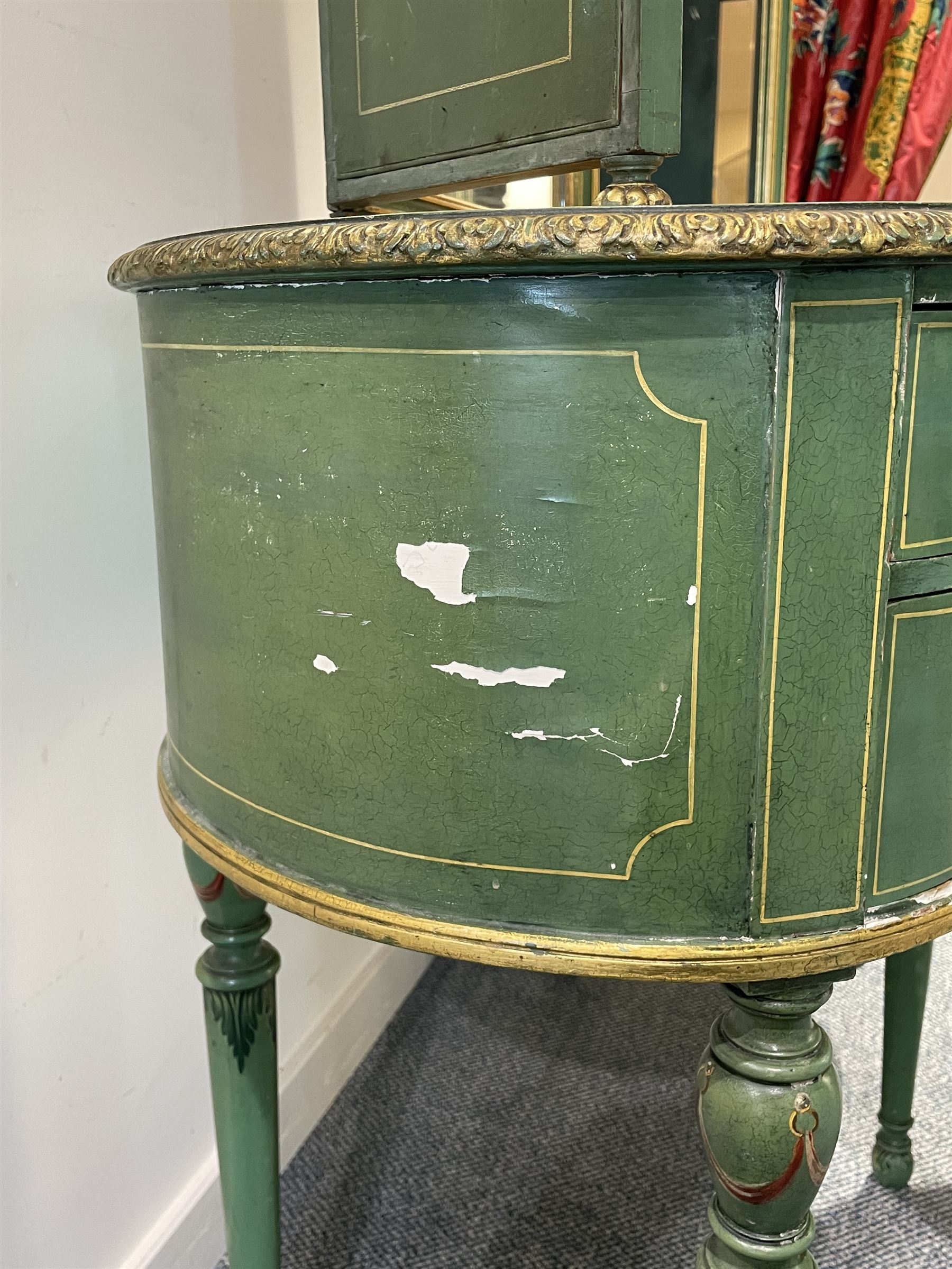 Edwardian Adam Revival green-painted and parcel gilt kidney-shaped dressing table, raised triple mirror back with shaped cresting, leather inset top within a trailing floral painted band and foliate carved edge, fitted with five drawers decorated with urn and floral bouquets, on turned supports painted with acanthus leaves and draped festoons; together with matching stool with cane seat 