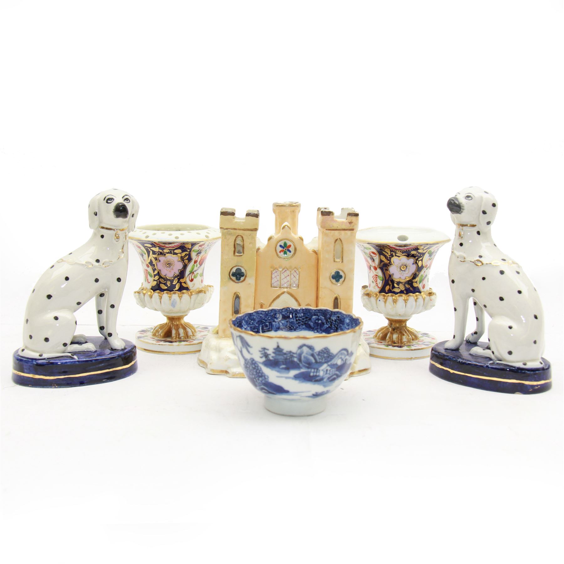 Pair of Staffordshire figures modelled as chained Dalmatians seated upon cobalt blue oval bases, H13cm, together with a Staffordshire pastille burner modelled as a castle, H12cm, a pair of 19th century Derby potpourri pots (lacking covers), and an 18th century blue and white tea bowl 