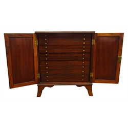  Regency ebony strung mahogany medal or coin collectors cabinet, with reeded top, two panel doors enclosing eleven drawers, shaped outsplayed bracket feet, W61cm, H68cm, D40cm  