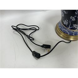 Pair of blue and white table lamps, each of baluster form, decorated with prunus blossom, within stylised borders, raised upon circular gilt base, excluding fittings H48cm