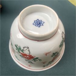 Three Chinese famille verte examples, approximately Yongzheng period, to include two teabowls and two saucers, each decorated with flowers and butterflies, two with sacred fungus mark within double rings, the teabowl with lotus mark, the other indistinct - possibly a Wan mark within lozenge (4)