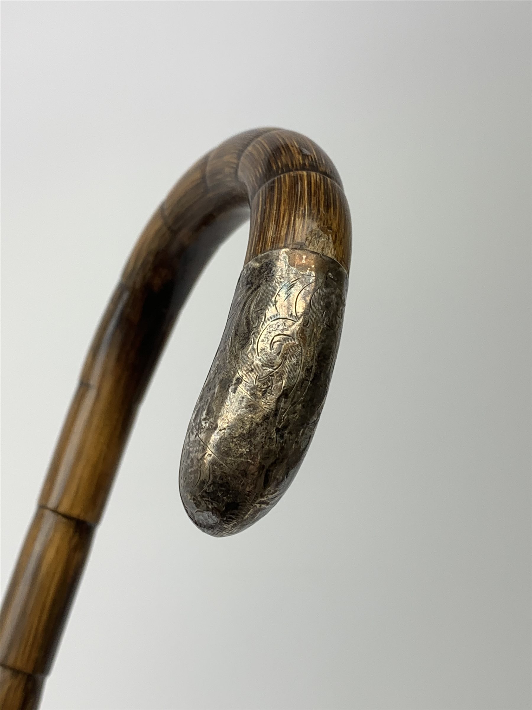 A 1920's silver mounted ebonized walking cane, the silver flat topped