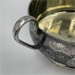 Early/mid 20th century Persian silver tea service, comprising circular serving tray, teapot, twin handled sucrier and cover, milk jug, five tea glasses with six silver holders, six tea spoons, and pair of sugar tongs, each profusely chased with foliate arabesque decoration, each bearing marks including 84 for 840 fineness, tray D40cm, teapot H16cm