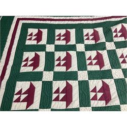 20th century quilt, with repetitive ship design to the centre within a cream red and green boarder, 227cm x 222cm