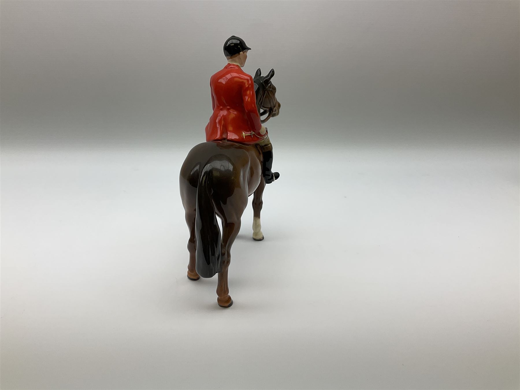 Beswick model of a huntswoman on grey horse model no 1730, and Beswick huntsman on brown horse model no 1501, both with printed mark beneath. 