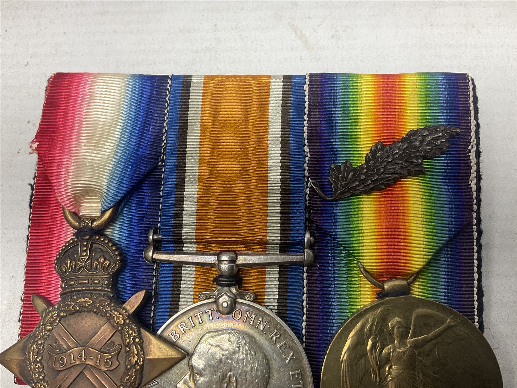 WW1 group of three medals comprising 1914-15 Star awarded to 1204 Pte. W.V. Furniss 20-London R. and British War Medal and Victory Medal with oak leaves awarded to Capt. W.V. Furniss; with ribbons; displayed on board for wearing; some biographical details
