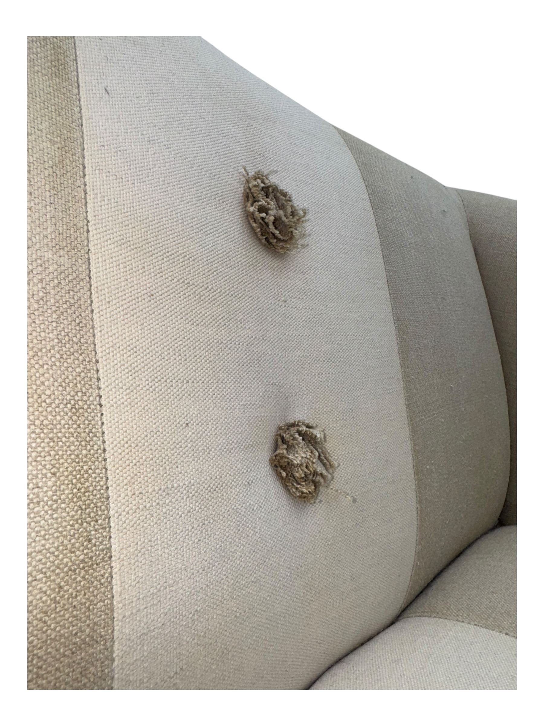 Pair of contemporary hardwood corner chairs, upholstered in broad alternating bands of neutral-toned fabric, each with two knotted rope buttons to the backrest, the whole raised on turned and lightly whitewashed supports terminating in castors