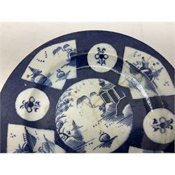 Mid-late 18th century pair of blue and white plates, probably Bow, the powder blue ground reserved with central roundel painted with Chinese river scenes surrounded by alternating fan shaped panels similarly decorated, and smaller roundels painted with floral sprays, with pseudo Chinese character marks to reverse, together with a Chinese plate decorated with blue and white peony design, all a/f, largest D22cm
