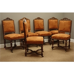  Set six early 20th century oak dining chairs, floral scrolled cresting rail, turned fluted supports connected by curved x-shaped stretcher, with suede upholstered back and seat  