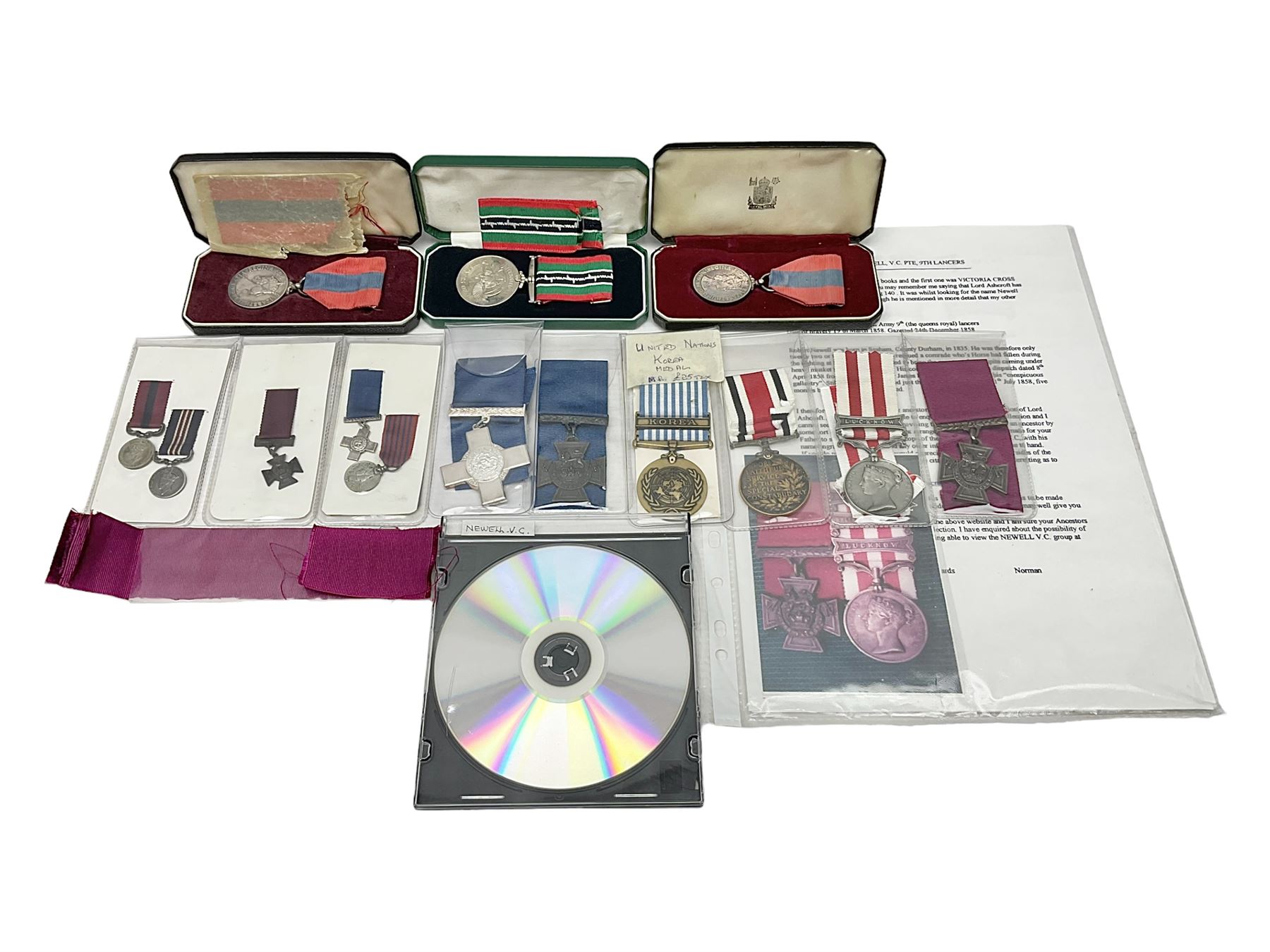 Two Imperial Service Medals to Elsie Hannah Ferguson and Fred Whitehead; each in original case; WWI Special Constabulary Medal to Inspr. Alfred W. Thompson; modern Prisoner of War Medal; cased; replica Victoria Cross and India Mutiny Medals with archive of information relating to Pte. Robert Newell V.C. 9th Lancers; replica Victoria Cross and George Cross with miniatures; and other replica medals etc