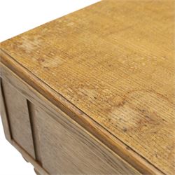 Leemings of Halifax (est. 1872) - Arts & Crafts oak side table, rectangular caddy top with raised moulded back, the frieze carved with central Yorkshire rose motif flanked by two drawers, raised on twin stylised lyre end supports formed of C-scrolls, united by shaped stretcher