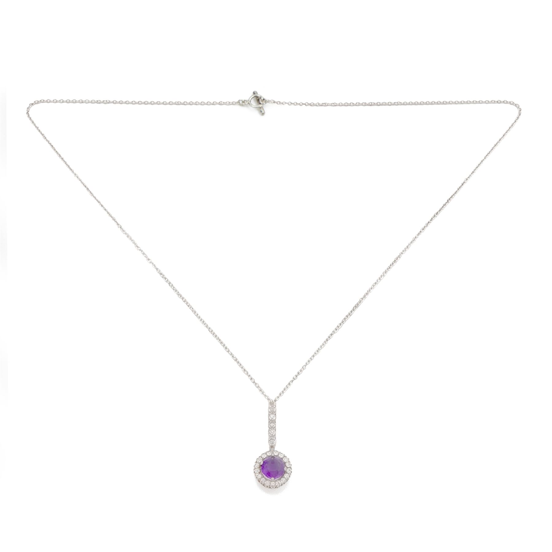 Early 20th century white gold silver amethyst and diamond pendant, round cut amethyst, surrounded by seventeen old cut diamonds, suspending from a five stone diamond set bail, to a silver chain necklace, total diamond weight approx 0.40 carat