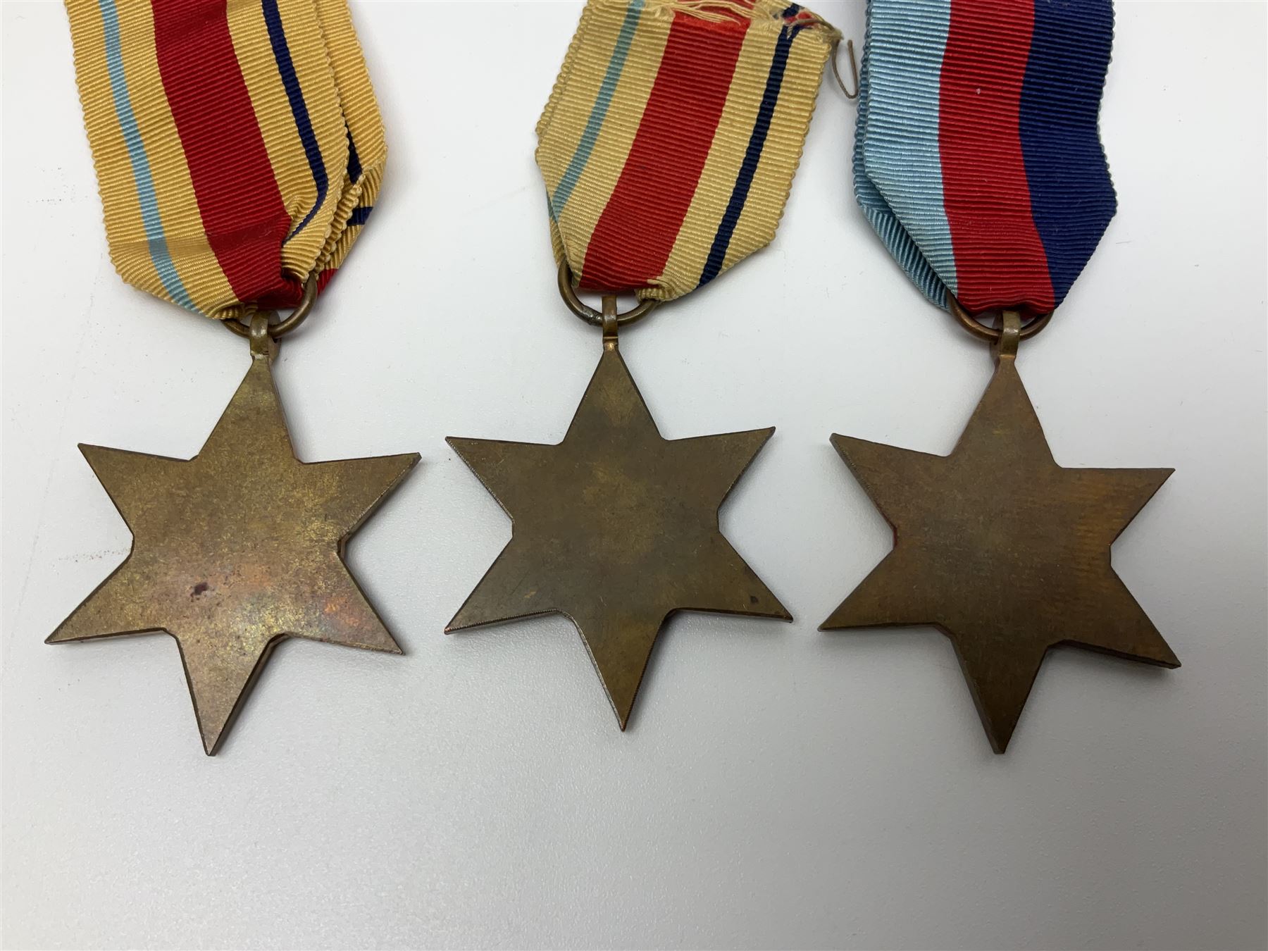 Ten WW2 medals comprising two 1939-1945 war medals, two Defence medals, two 1939-1945 Stars, two Africa Stars, France & Germany Star and Burma Star; together with bar of four miniature medals; all with ribbons