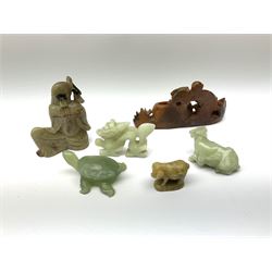 A Chinese carved jade model of a water buffalo, L6cm, together with a tortoise, dragon, and three soapstone models, the first example carved as a sage, the second example as a money with open 'pot', and the third example as a pig. (6). 