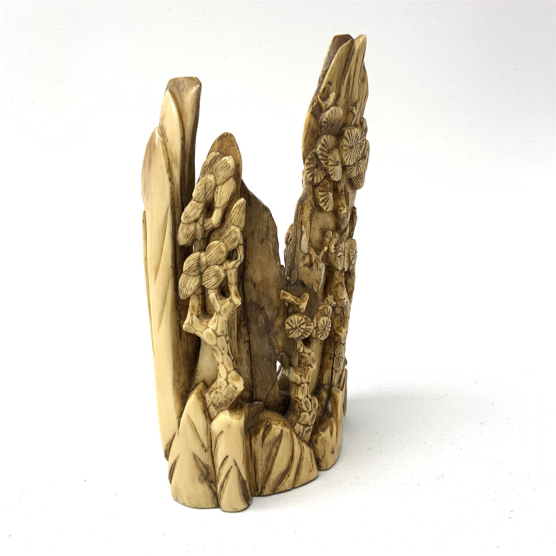 19th century Japanese carved mammoth ivory figure group, modelled as Fukurokuju and two attendants, carved verso with prunus, H17cm