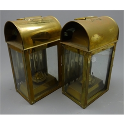  Pair of ship's brass saloon lamps, each with arched vented top, three glass sides, mirrored reflector backs and oil burners, H32cm (2)  
